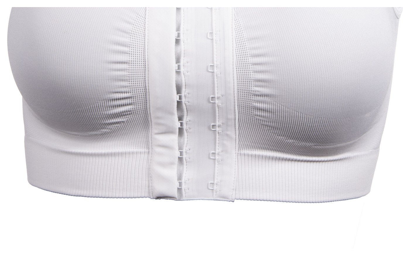 Close view of the lower front of the white Reco Bra, showing the wide ribbed hem band, the knitted compression zone above it and the two rows of hook and eye fastenings